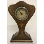 A wooden inlaid alarm clock with Art Nouveau style decoration. In working order.