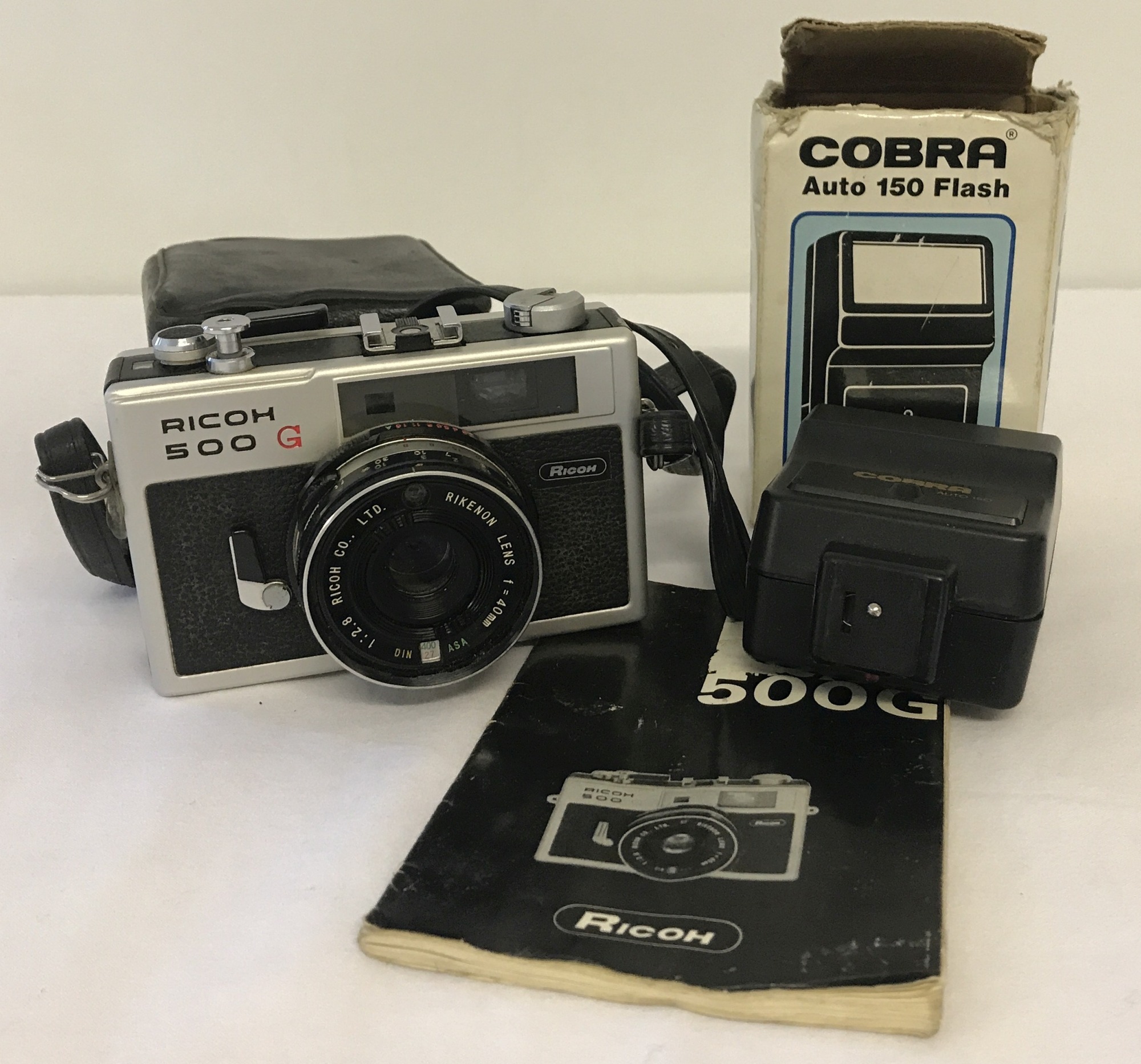 A vintage Ricoh 500G camera complete with instruction booklet and case.