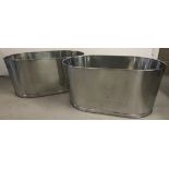 A pair of large Bollinger Champagne buckets with engraved details to sides.