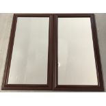 A pair of modern framed wall mirrors with brown wood effect frames.