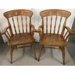A pair of pine carver kitchen chairs.