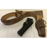 An adjustable tan leather gun belt with bullet holders.