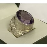 A vintage silver dress ring set with a large oval cut amethyst.