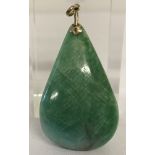 A teardrop shaped jade pendant with gold fixing and bale. Tests as 8ct gold.