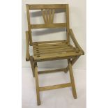 A vintage child's light wood folding chair.