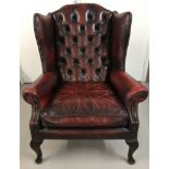 A vintage Wing back leather armchair with button back detail and cabriole front legs.