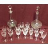 2 vintage glass decanters with a collection of liqueur, sherry and dessert wine crystal glasses.