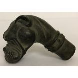 A vintage bronze walking cane handle in the shape of a boxer dog.
