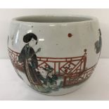 A white glaze Chinese jardinière with garden and oriental figure decoration.
