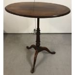 A small Victorian oval topped occasional table on tripod pad feet.