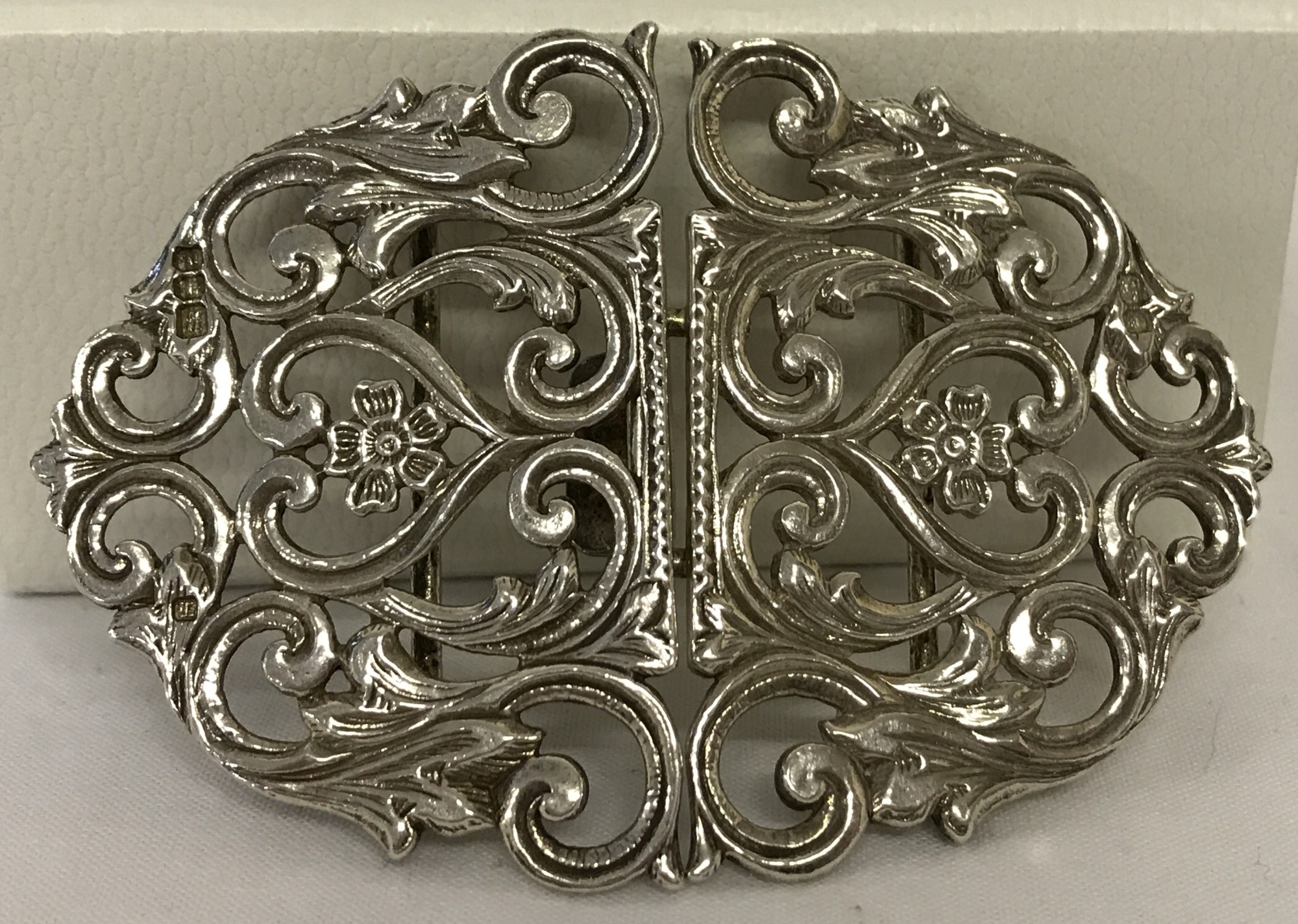 An ornate silver belt buckle. Hallmarked London 1985.