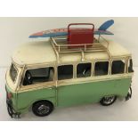 A modern painted tin plate camper van model.