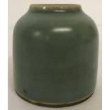 A small green glazed brush pot with ring mark to underside.