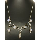 A decorative silver and moonstone necklace.