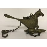 An Oriental brass, bird shaped incense burner suspended from a chain, with decorative hook.