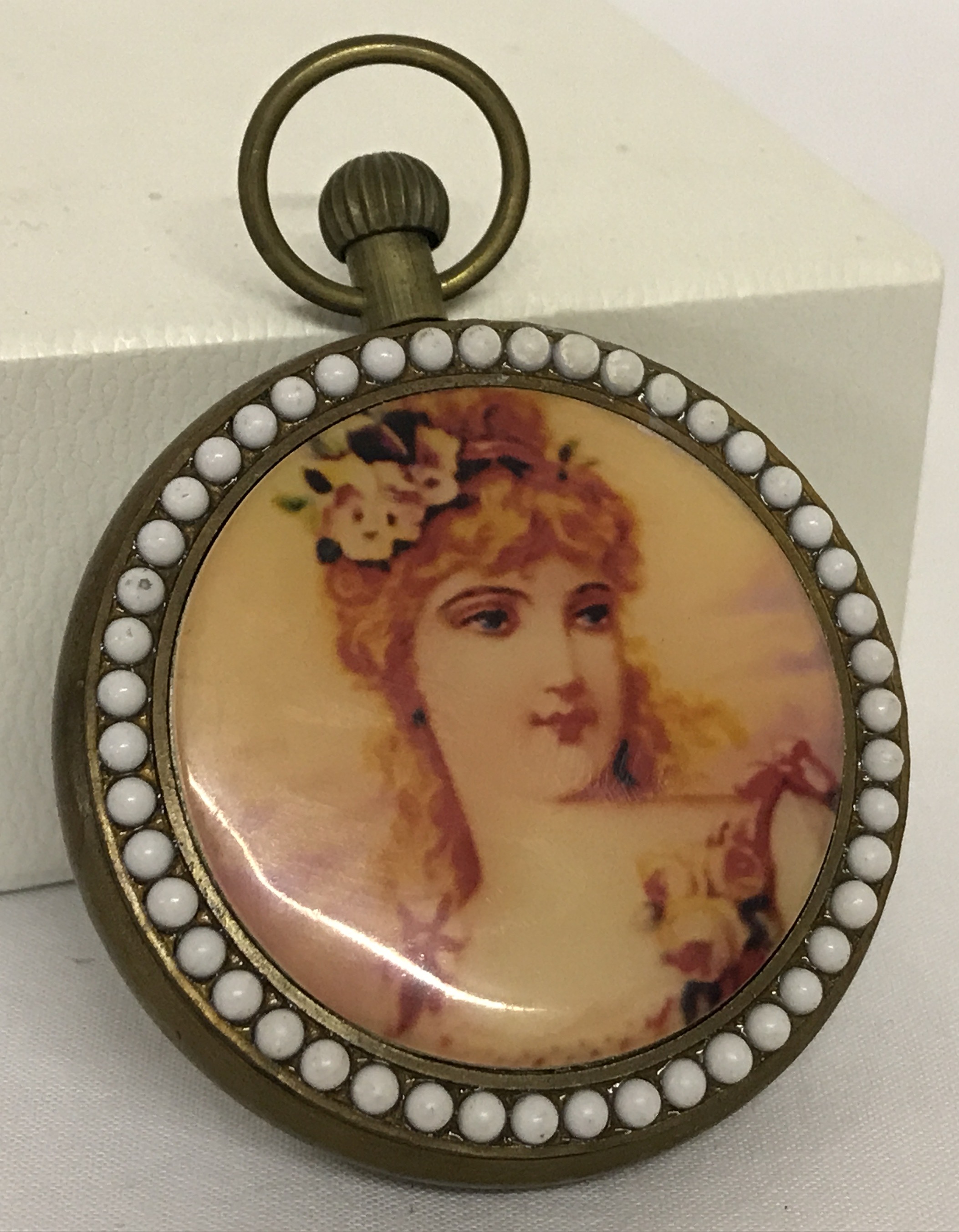 A brass cased pocket watch with beaded detail to surround front and back. - Image 2 of 2