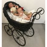 A reproduction vintage style dolls pram with lace edge pillow and covers.