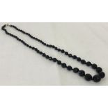 A vintage French jet graduating bead necklace with 9ct gold clasp.