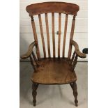 An antique slat back Grandfather chair with turned detail to legs and arm supports.