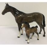 2 Beswick horse figurines. A Bois Roussell Racehorse together with a foal (a/f).