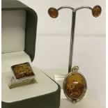 3 pieces of amber jewellery. A silver gilt oval amber pendant.