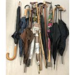 A collection of 15 vintage and modern umbrellas, parasols and walking sticks.