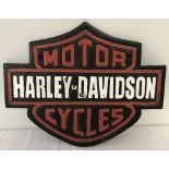 A painted cast iron Harley Davidson motorcycles wall plaque with fixing holes.