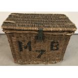 A large wicker basket with wicker handles.