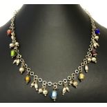 A modern design necklace with metal and foil glass drop bead decoration.