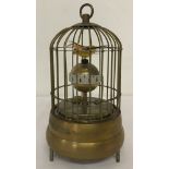 An ornamental wind up birdcage clock.