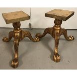 A pair of gilt painted wooden claw and ball feet tripod display stands.