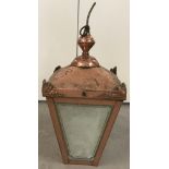 A copper ceiling porch light with brass hanging ring.