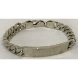 A heavy silver curb chain identity bracelet.