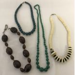 A collection of 4 natural stone and glass bead dress necklaces.