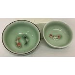 2 small ceramic Japanese bowls with fish detail to inner bowl, in pale green glaze.