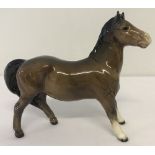 A Beswick ceramic Pony figurine (Girl's Pony) #1483, in brown colourway.
