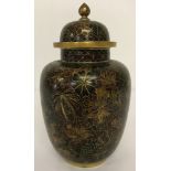 A cloisonné lidded temple jar, in brown tones, with floral detail.