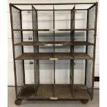 A large vintage metal laundry rack on wheels.