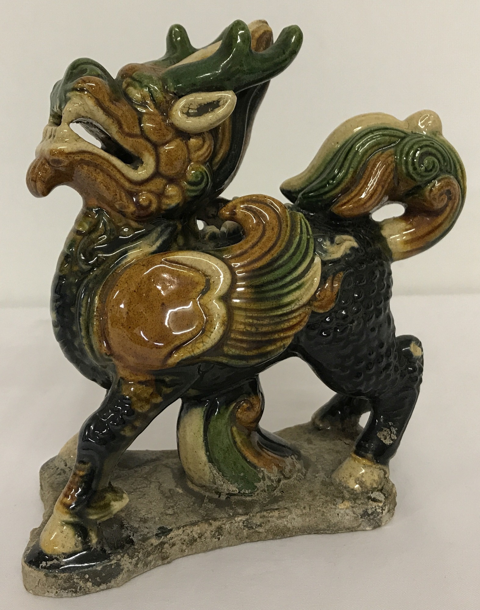 A Chinese porcelain figurine of a Foo Dog, with majolica style glaze.