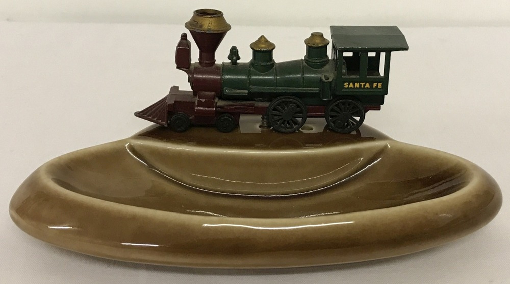 A circa 1960's Wade brown ceramic pin tray mounted with Matchbox diecast vehicle.