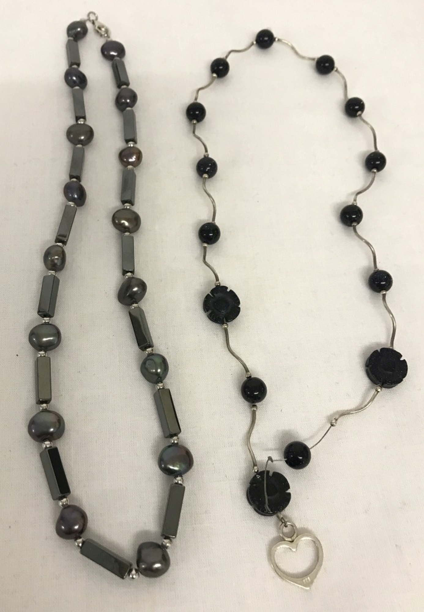 A hematite and grey freshwater pearl necklace with 925 clasps by The Genuine Gem Company.