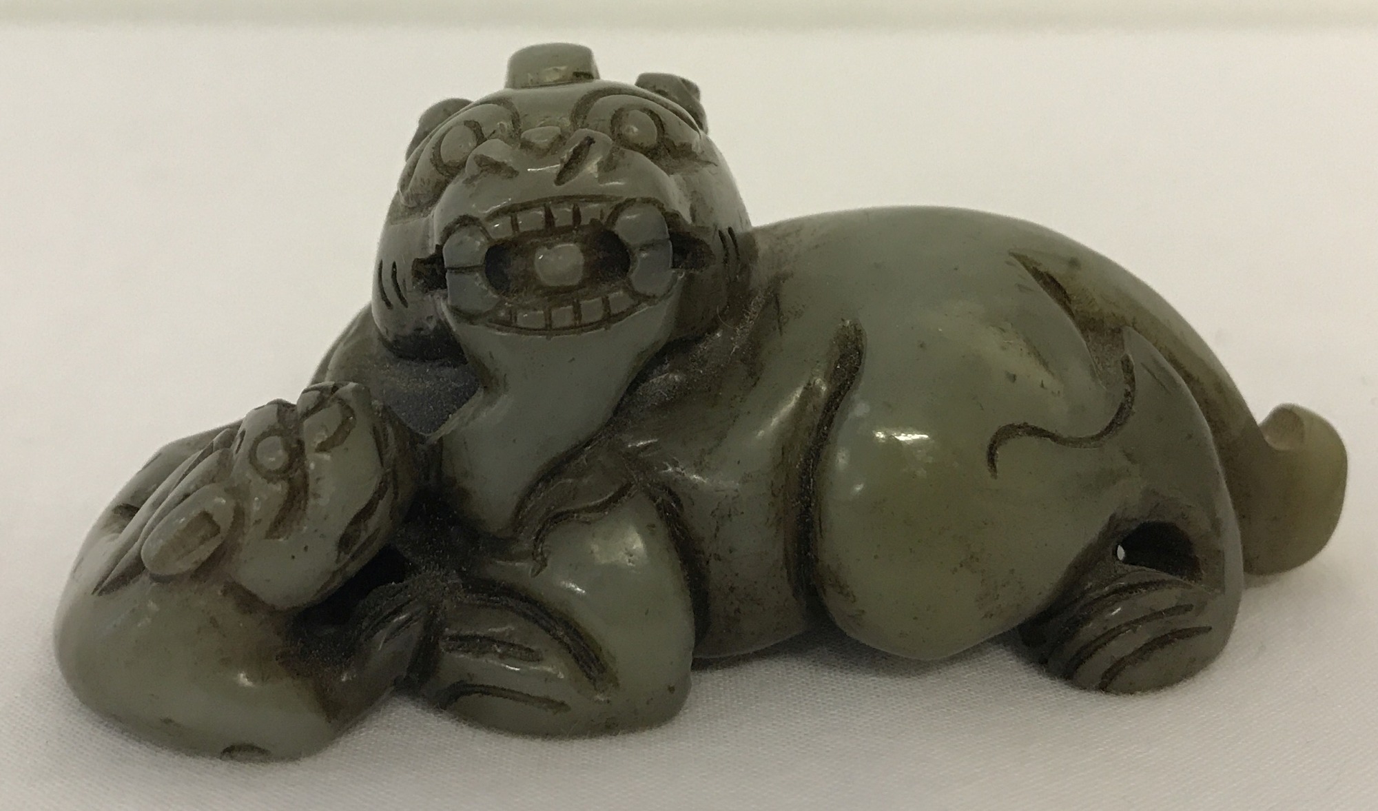 A carved jade figure of a Chinese Foo Dog.