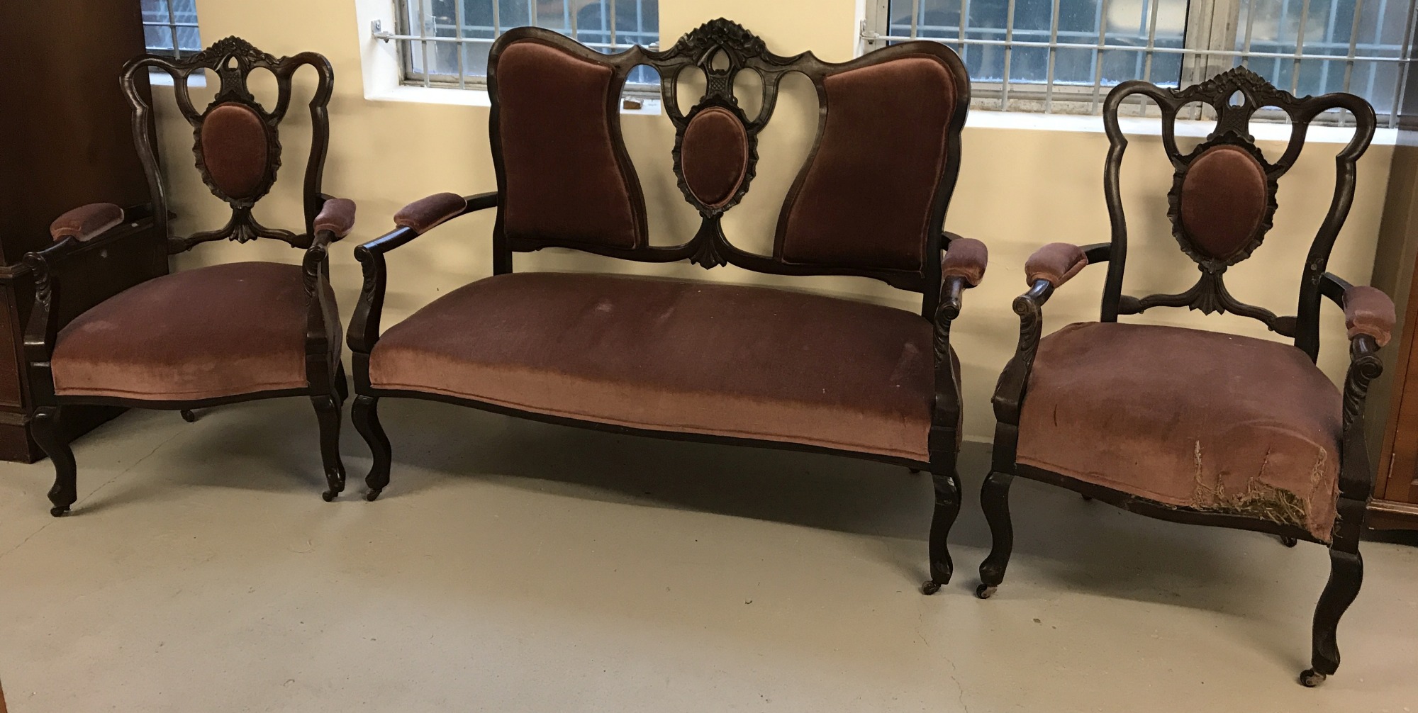 A Victorian 2 seater wooden framed settee with 2 matching arm chairs.