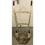 A vintage metal framed sack barrow, painted white.