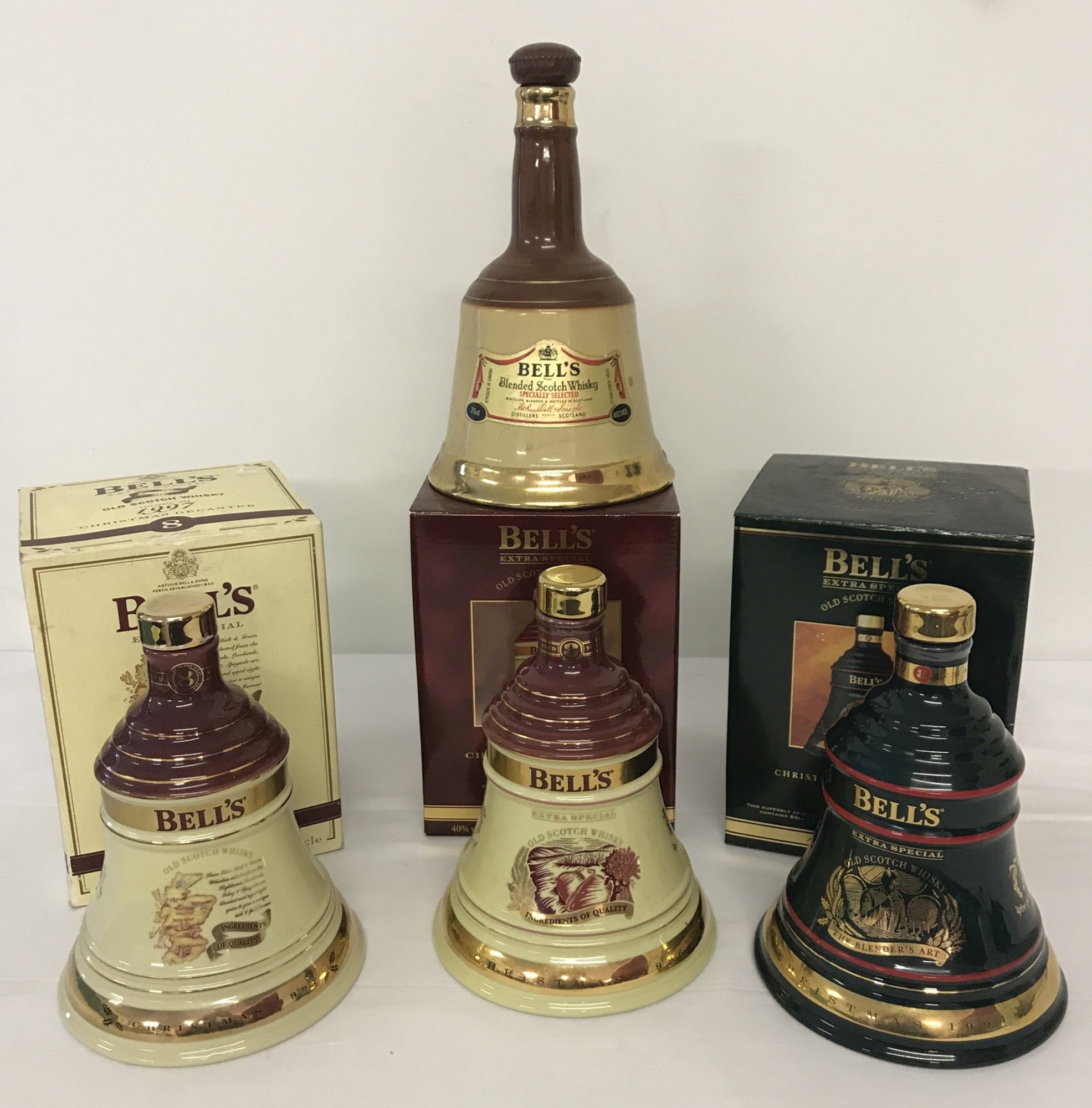 A collection of 4 Wade ceramic Bells whisky bell shaped decanters (empty).