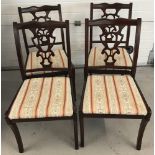 A set of 4 reproduction dining chairs. With decorative work to backs.