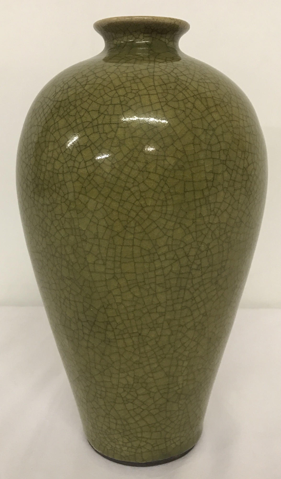 A small necked green crackle glaze vase.