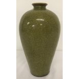 A small necked green crackle glaze vase.