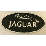 A painted cast iron, oval shaped, Jaguar wall plaque with fixing holes.