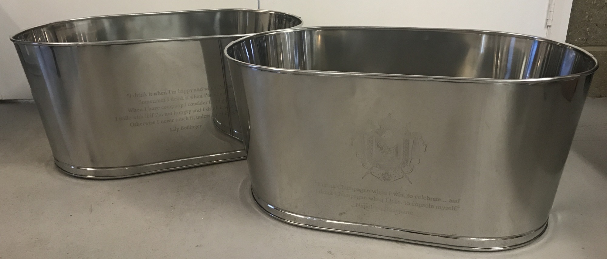 A pair of large Bollinger Champagne buckets with engraved details to sides.